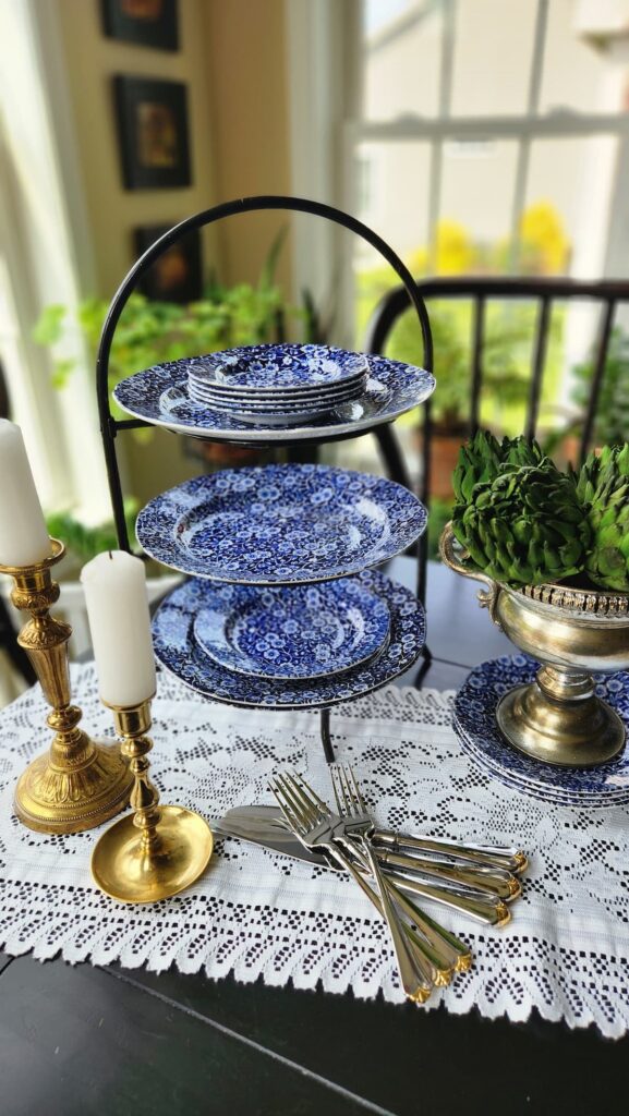 blue and white dishes stacked on dining table in tiered stand 