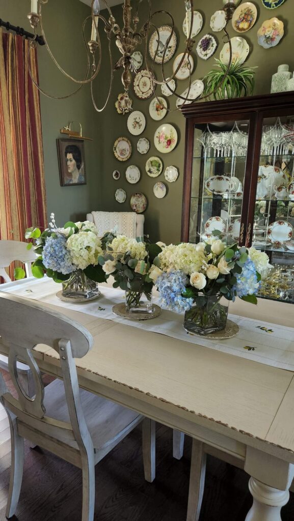 dining room table with three blue arrangements on table