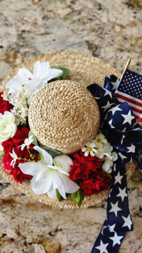 overhead view of straw hat wreath with red, white and blue colors