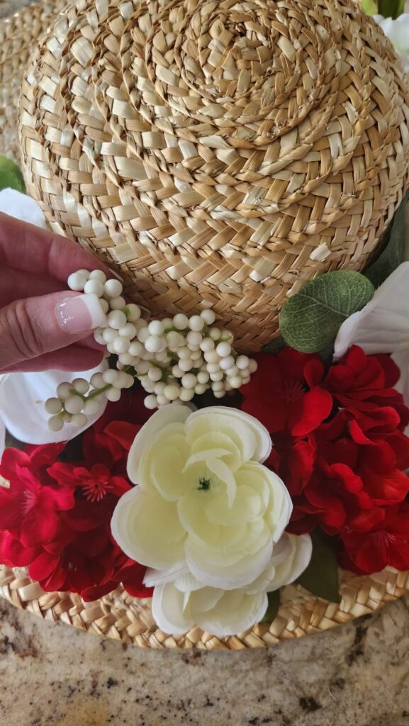 adding white faux berries to diy door wreath