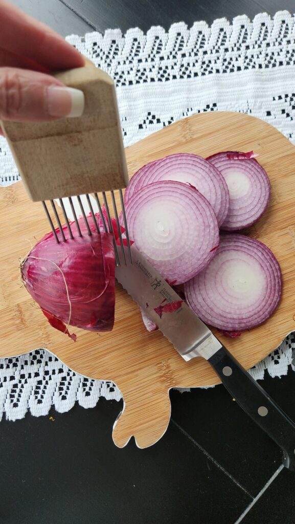 onion being sliced with knife overhead photo