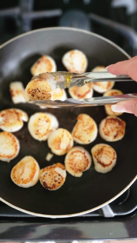 scallops being browned in non stick pan