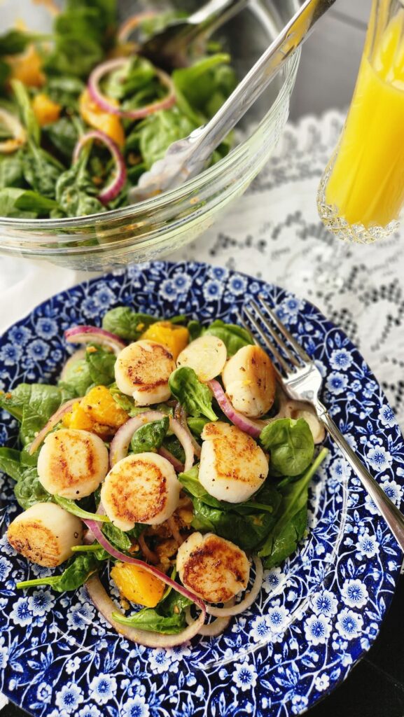 overhead of scallop salad with orange mimosa on side