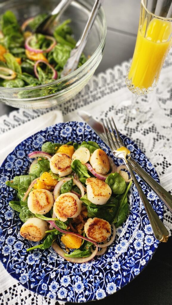 scallop salad overhead photo with mimosa on side of dish