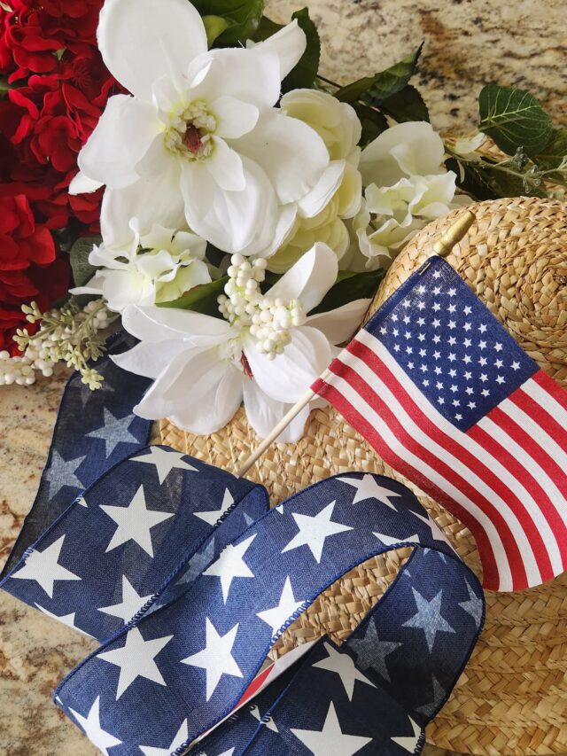 blue star ribbon, straw hat and red and white flowers fo decorate a hat