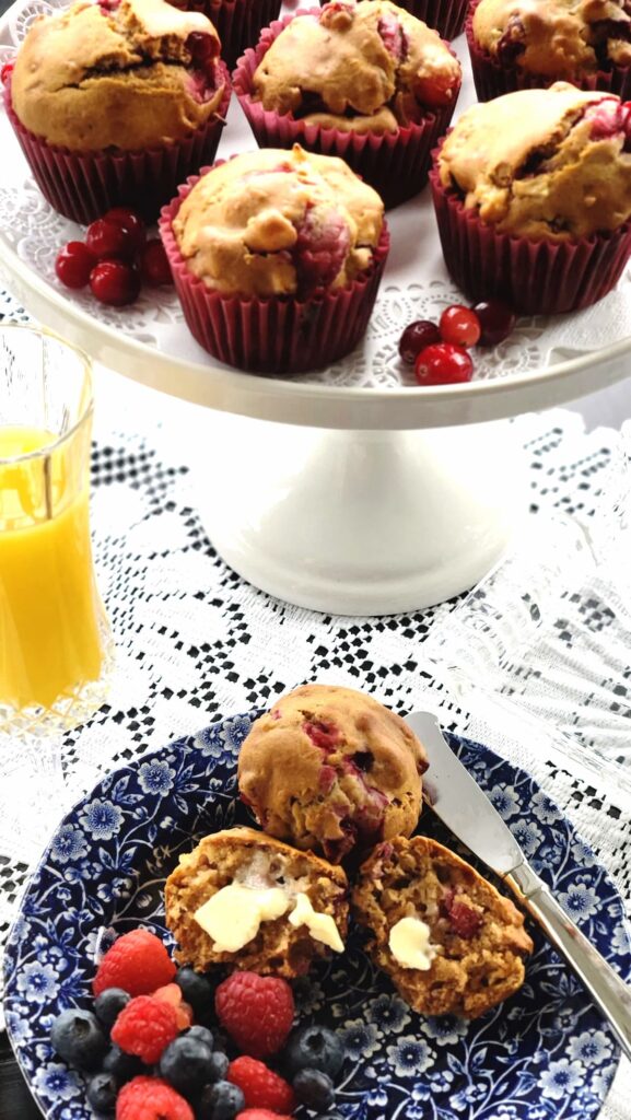 cranberry walnut muffins on a white pedestal dish 