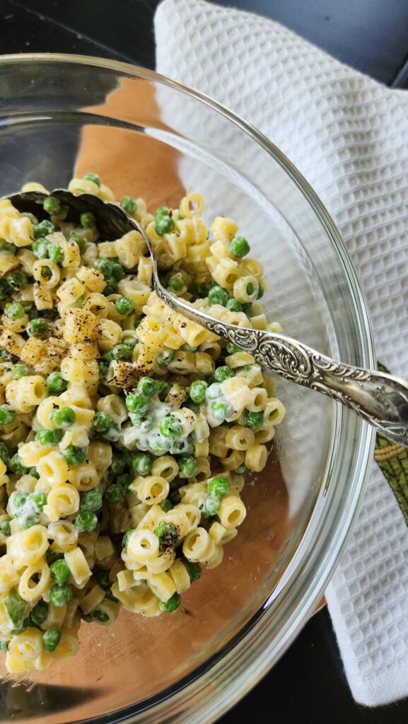 pasta and pea salad in glass bowl