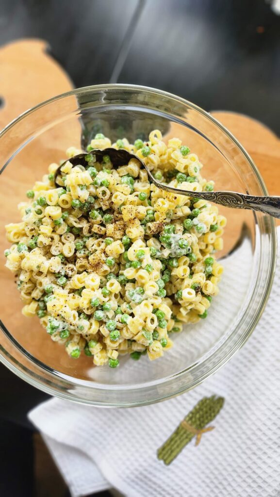 overhead photo of pea and pasta recipe in glass bowl