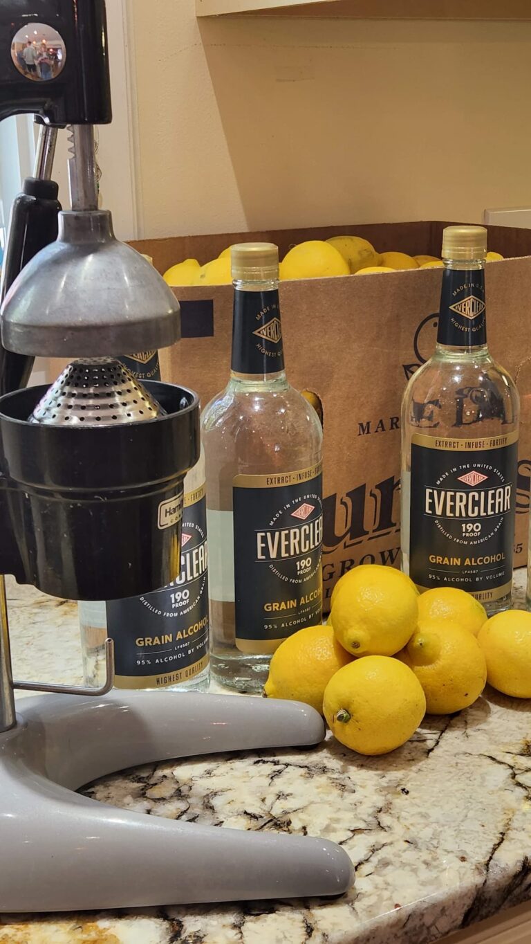 lemons on counter with vodka bottles for making limoncello