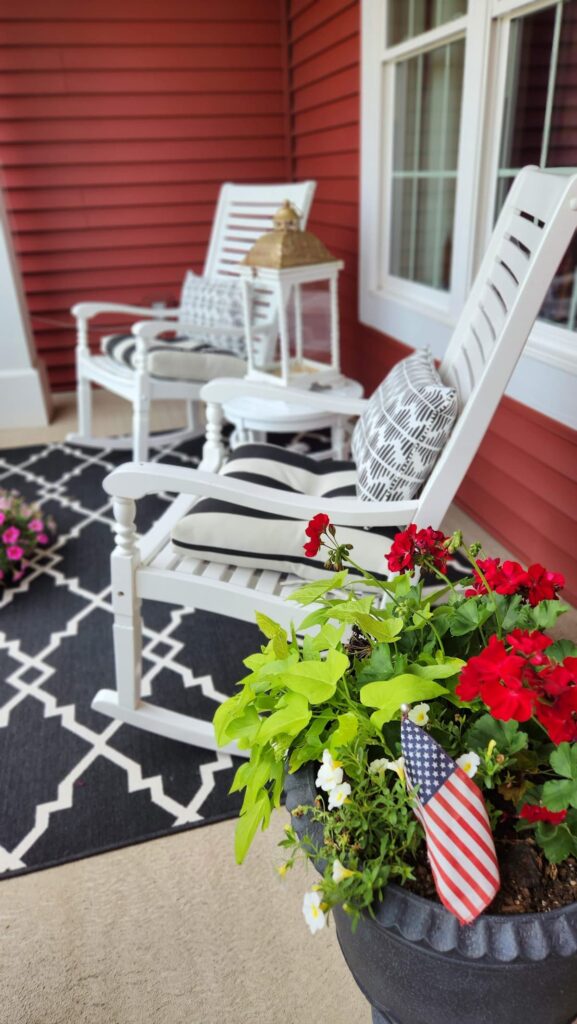 white rocking chair with black and white cushions with black and white pillows