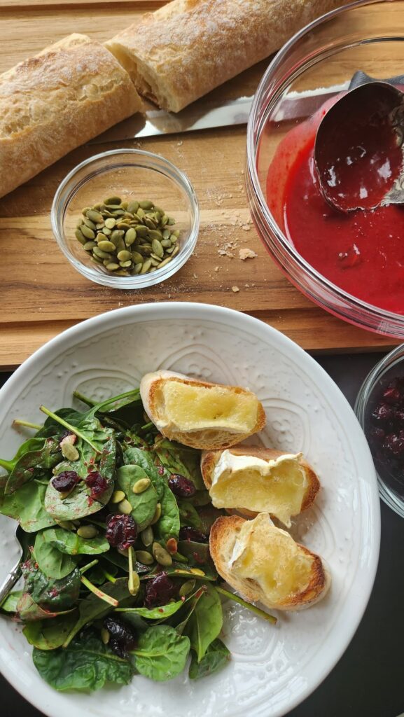 overhead view of spinach salad with brie toast