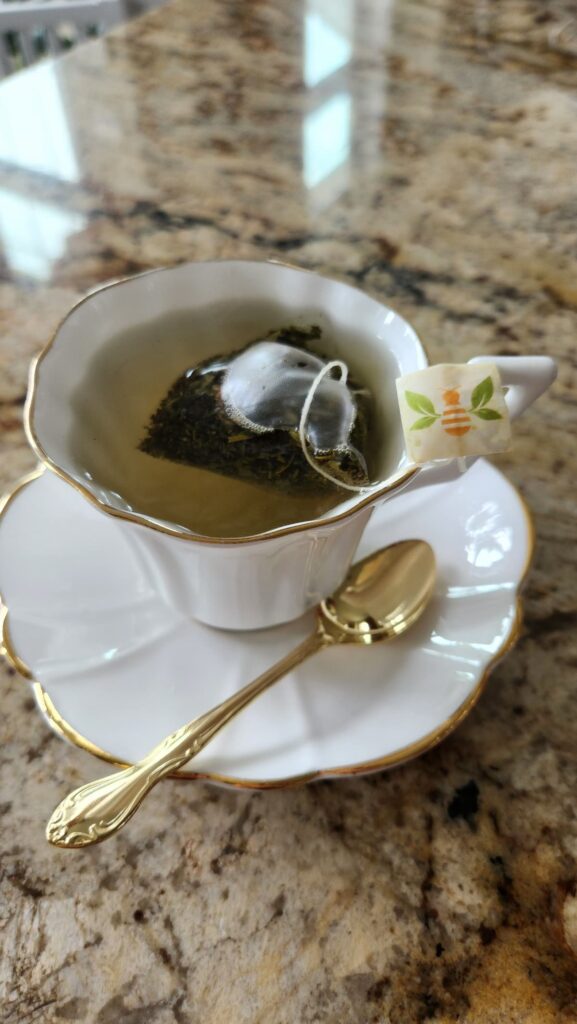 white tea cup filled with tea on counter