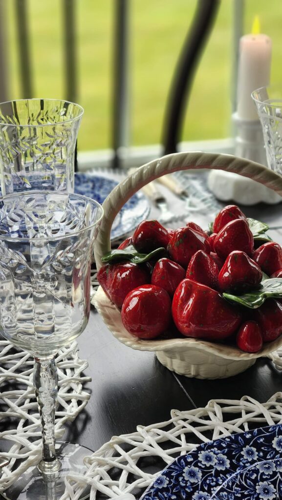 ceramic bowl with ceramic strawberries on table