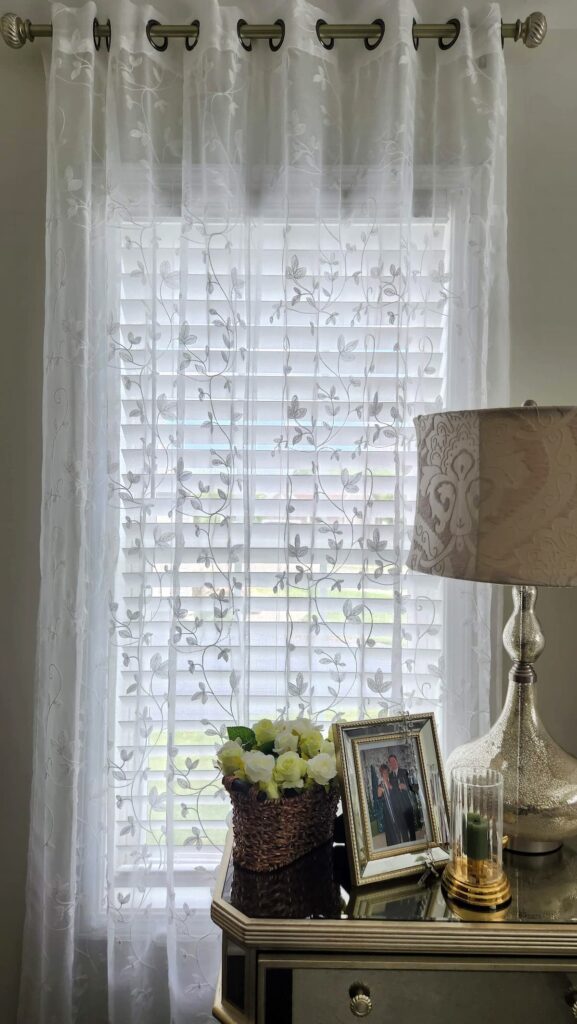 white sheer curtains handing in bedroom