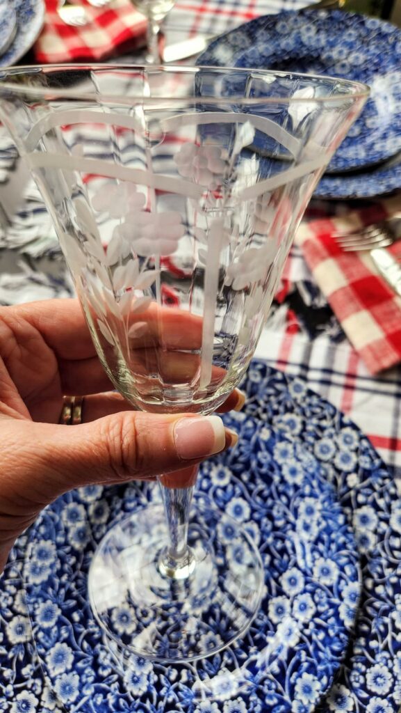 vintage etched stemware wine glass in ladies hand