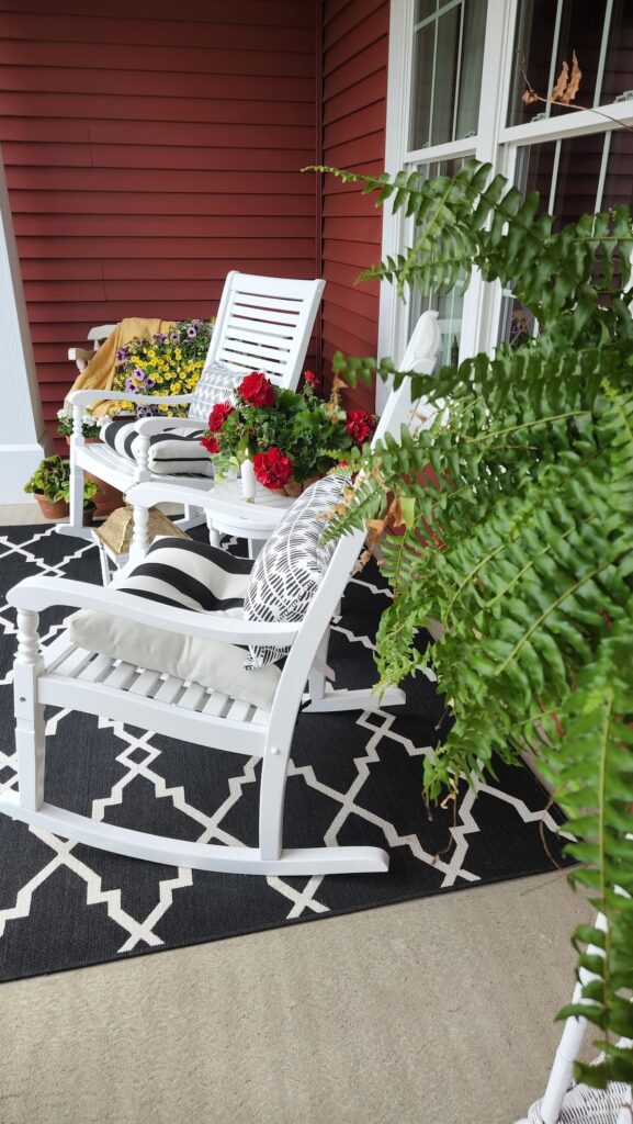 front porch white rocking chiars with black and white rug on porch