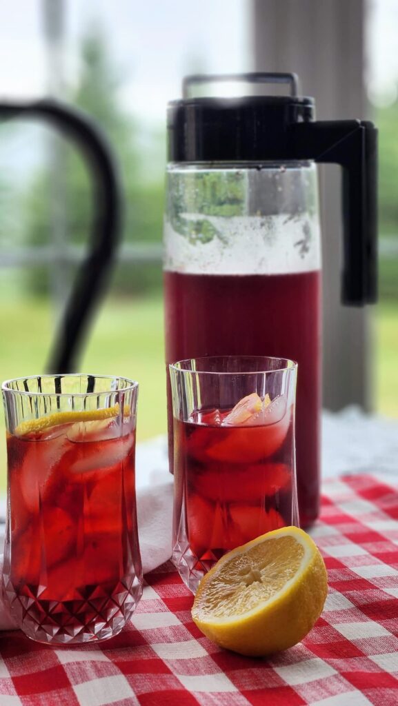 crimson berry red tea in two glasses with lemon slice 