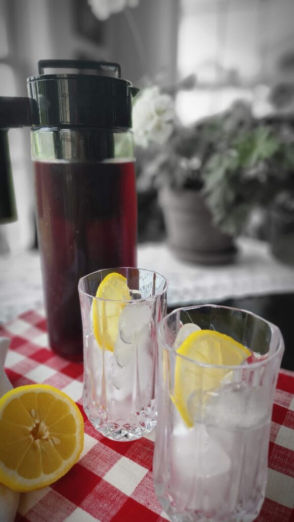 two glasses with ice cubes and lemon slice ready for iced tea