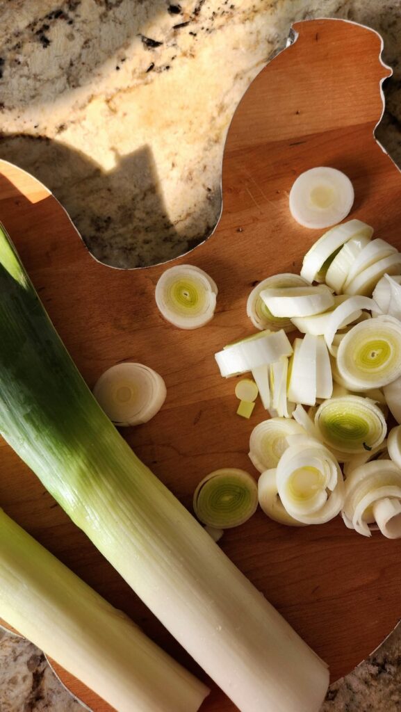 thinly sliced leeks on cutting board