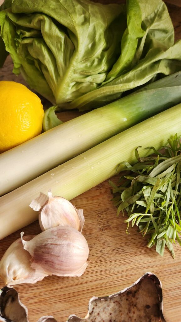 leeks on cutting board with lemon, garlic and tarragon