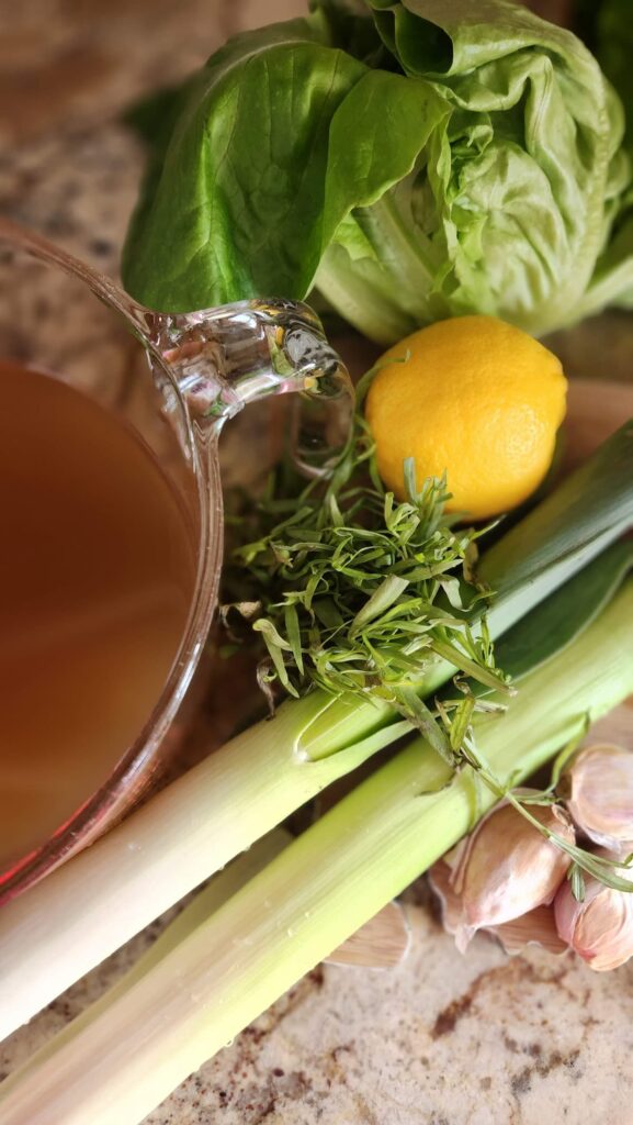 vegetable broth, leeks, lemon and tarragon overhead photo