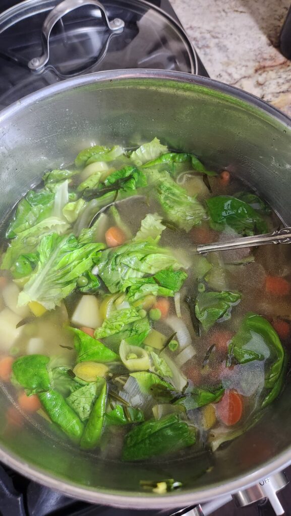 spring lettuce added to soup pot