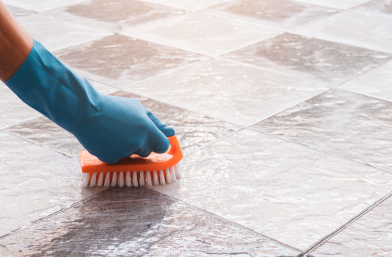 grout brush scrubbing floor tile