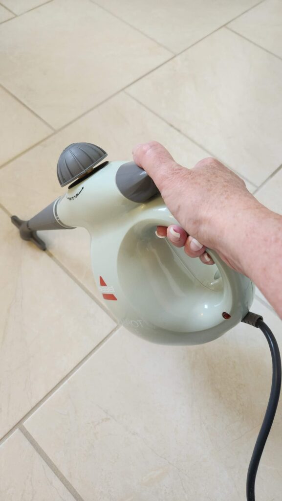 overhead steam grout cleaner on bathroom floor