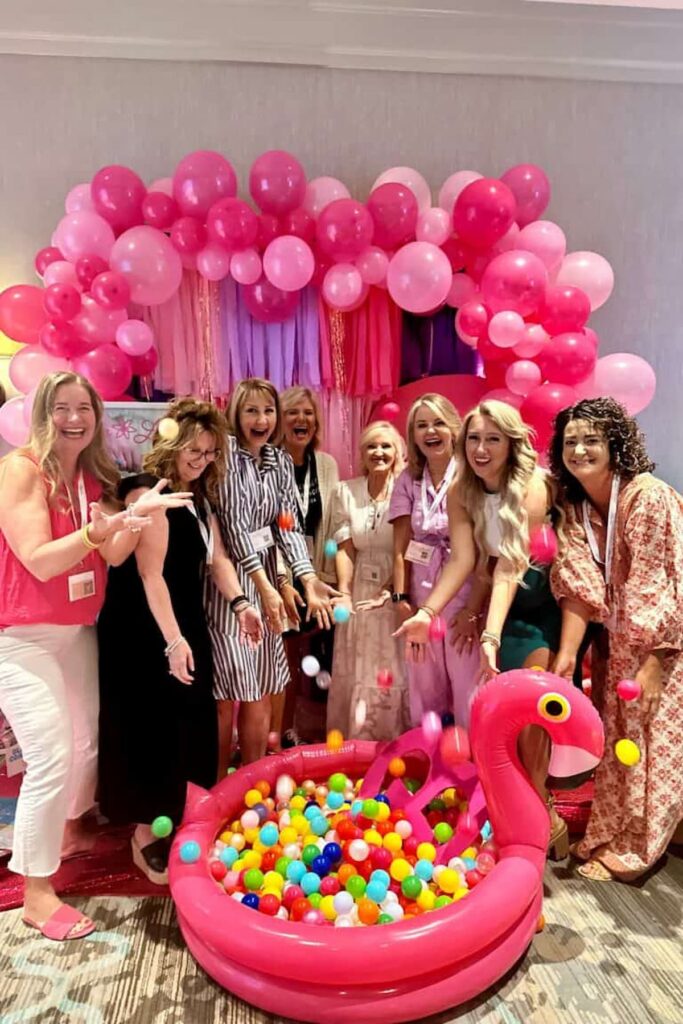 a group of blogging friends getting silly with the pink plastic balls