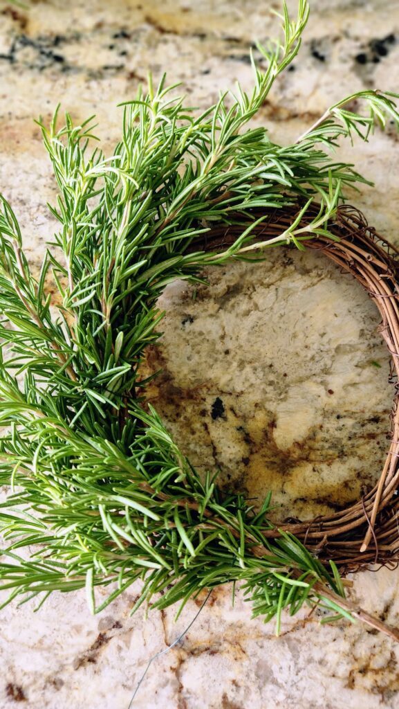 rosemary sprigs half way around the grapevine wreath