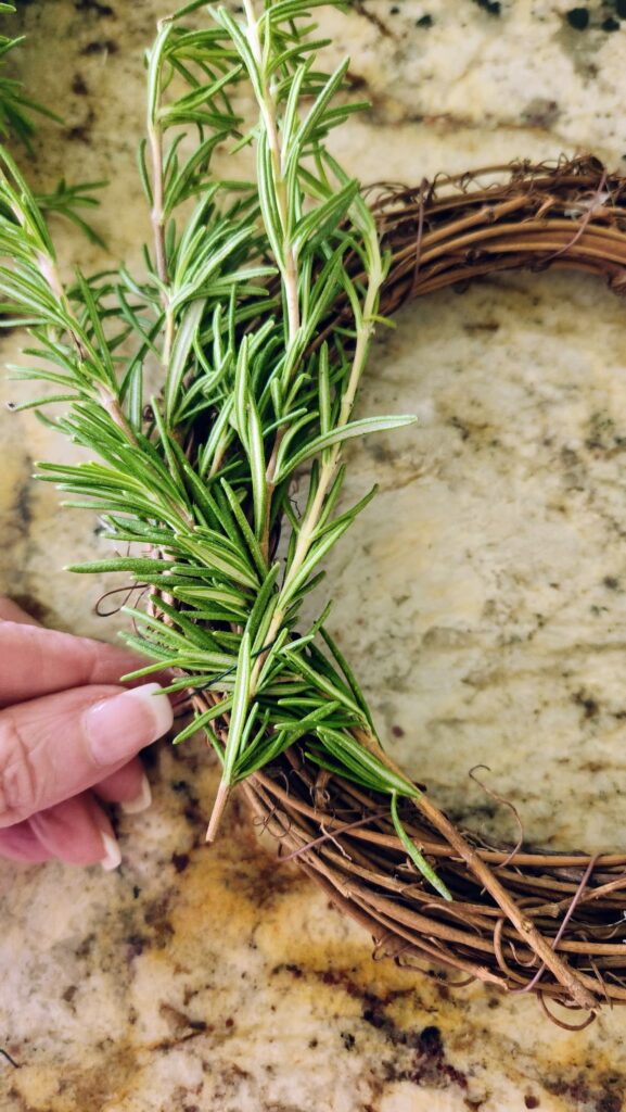 three sprigs of rosemary to be added to grapevine wreath