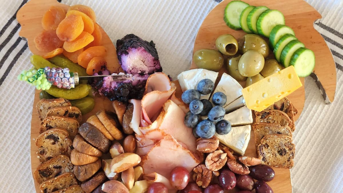 small charcuterie board on a rooster shaped cutting board