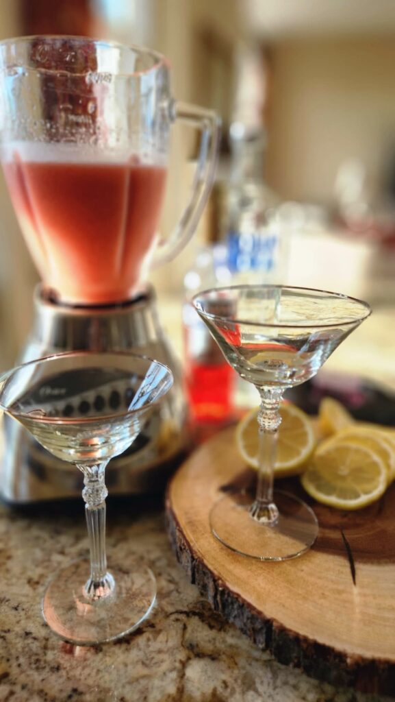 martini glasses with blender of strawberry vodka freeze waiting to be poured