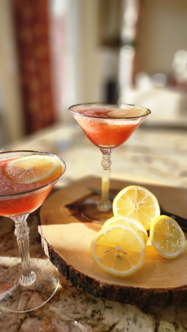 two martini style glasses with pink lemonade vodka freeze in them