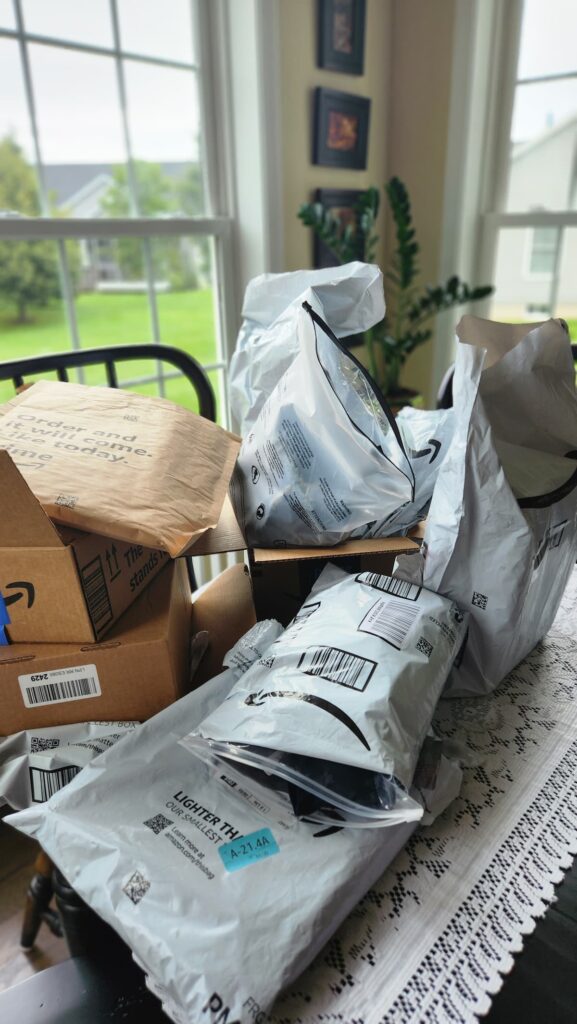 kitchen table piled high with amazon packages