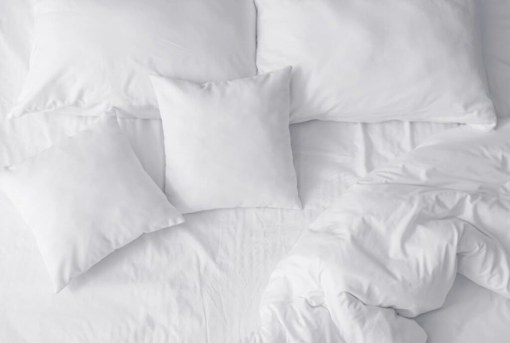 overhead view of mattress with white pillows