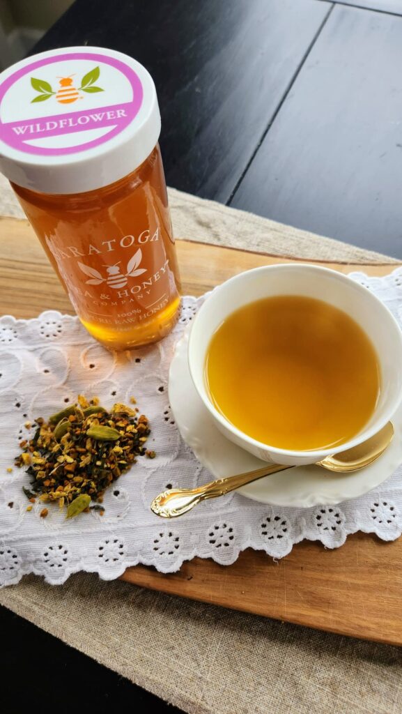 Golden dragon chai tea in white cup with wildflower honey jar next to it