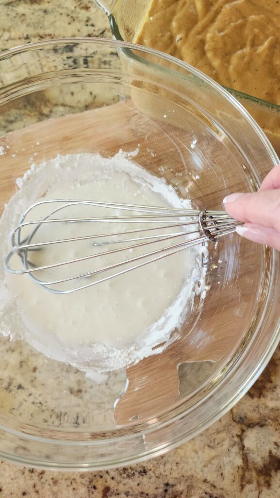 pumpkin  bread icing mixed in glass bowl ready to go on pumpkin bread