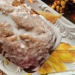 pumpkin bread with pumpkin bread icing drizzled on top on white dish