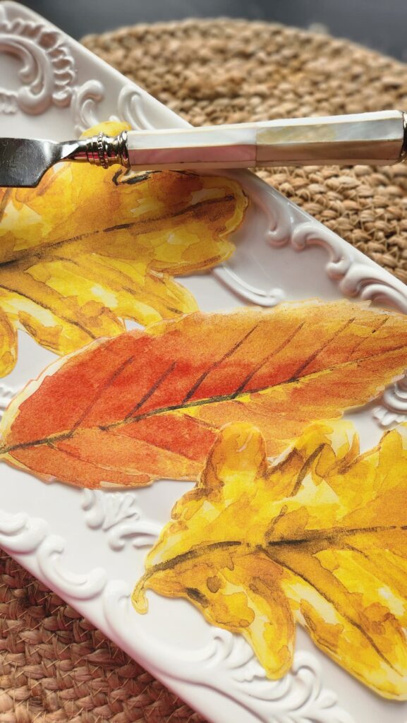 parchment paper leaves on serving dish that will decorate the plate for pumpkin bread