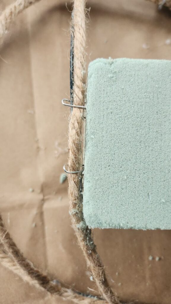 paper clips attaching the foam brick to the wire frame