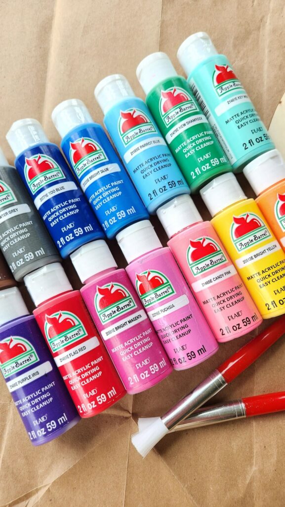 overhead view of acrylic paint bottles in many colors
