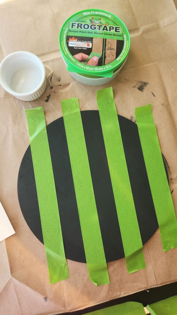 round wooden door hanger with frog tape stripes b