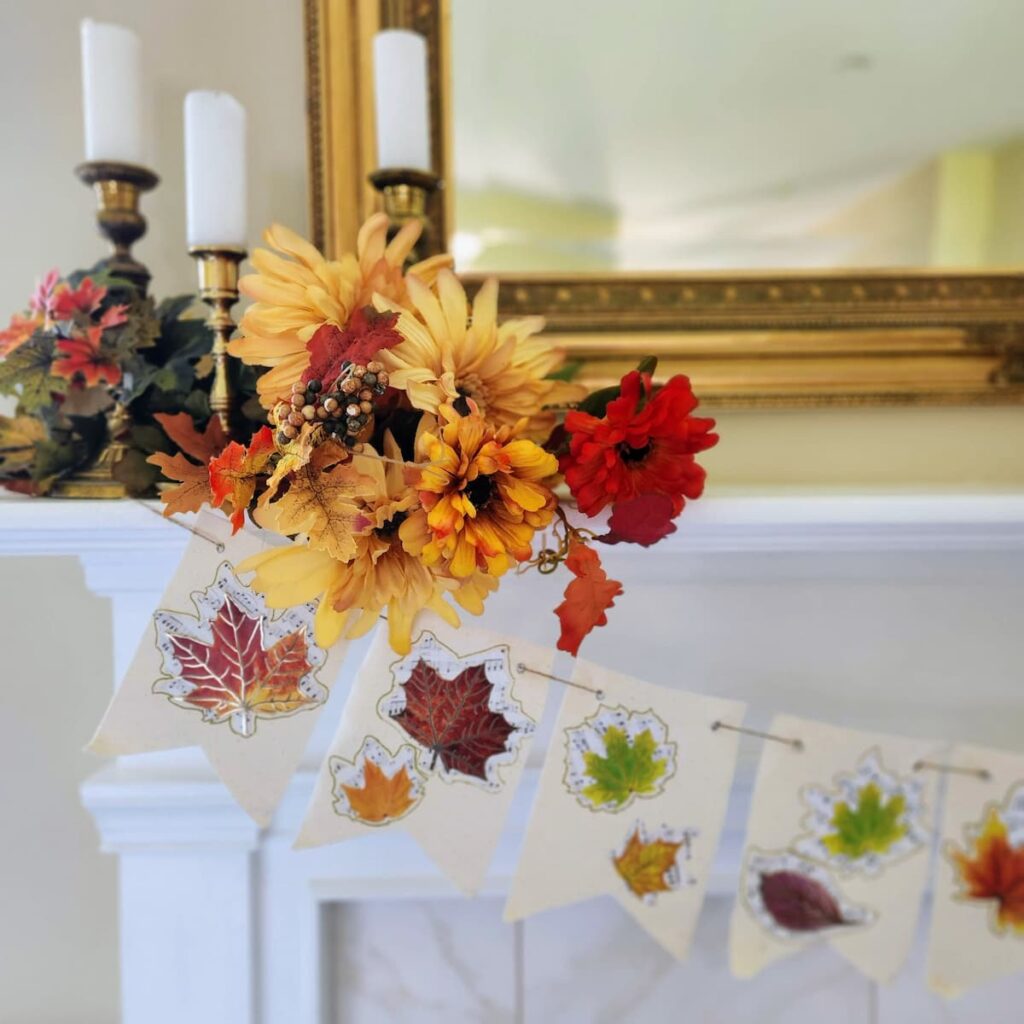 Fall mantel banner with leaves hung from a mantel