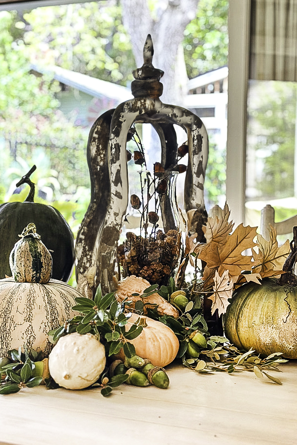 chippy wood centerpiece with pumpkins and fall foliage