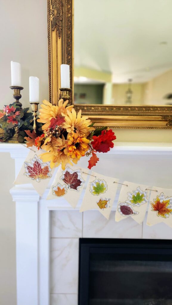 fall mantel banner on fireplace with candles on top of shelf