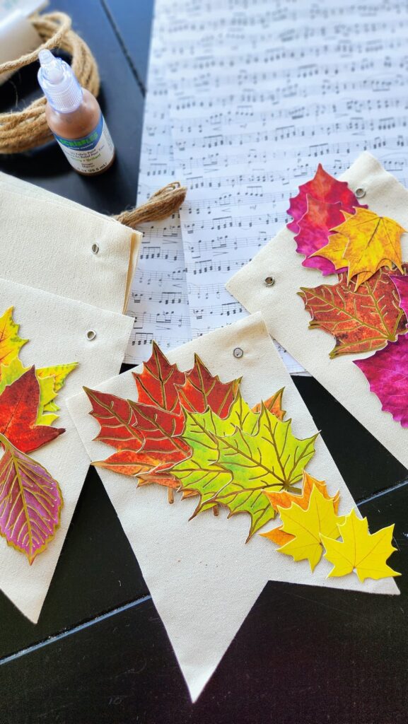 fall faux leaves on table with canvas banner and sheet music