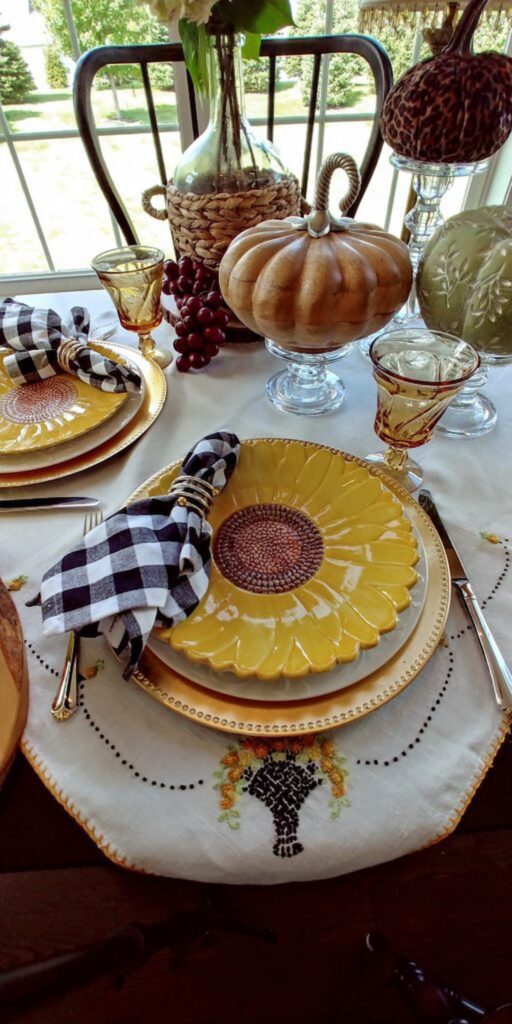 wooden pumpkin with sunflower dishes on table top