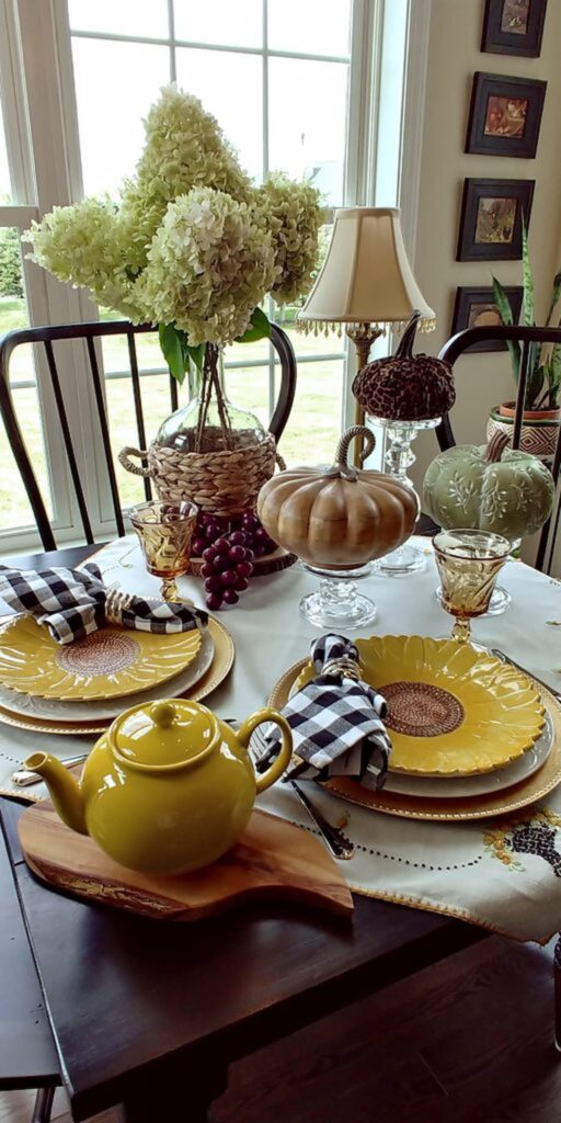 yellow sunflower dishes and jar filled with hydrangeas on table taop