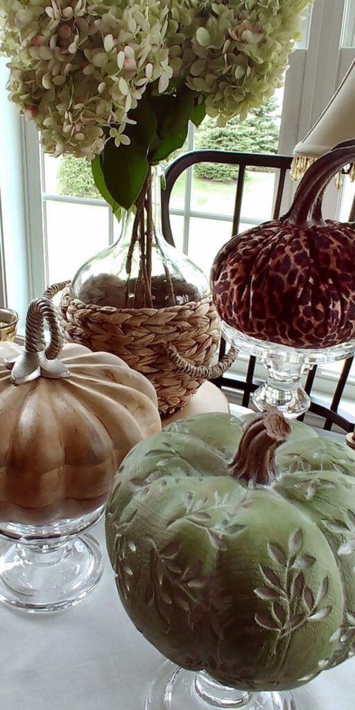 wooden pumpkins, and leopard pumpkin on table with jar of dried hydrangeas